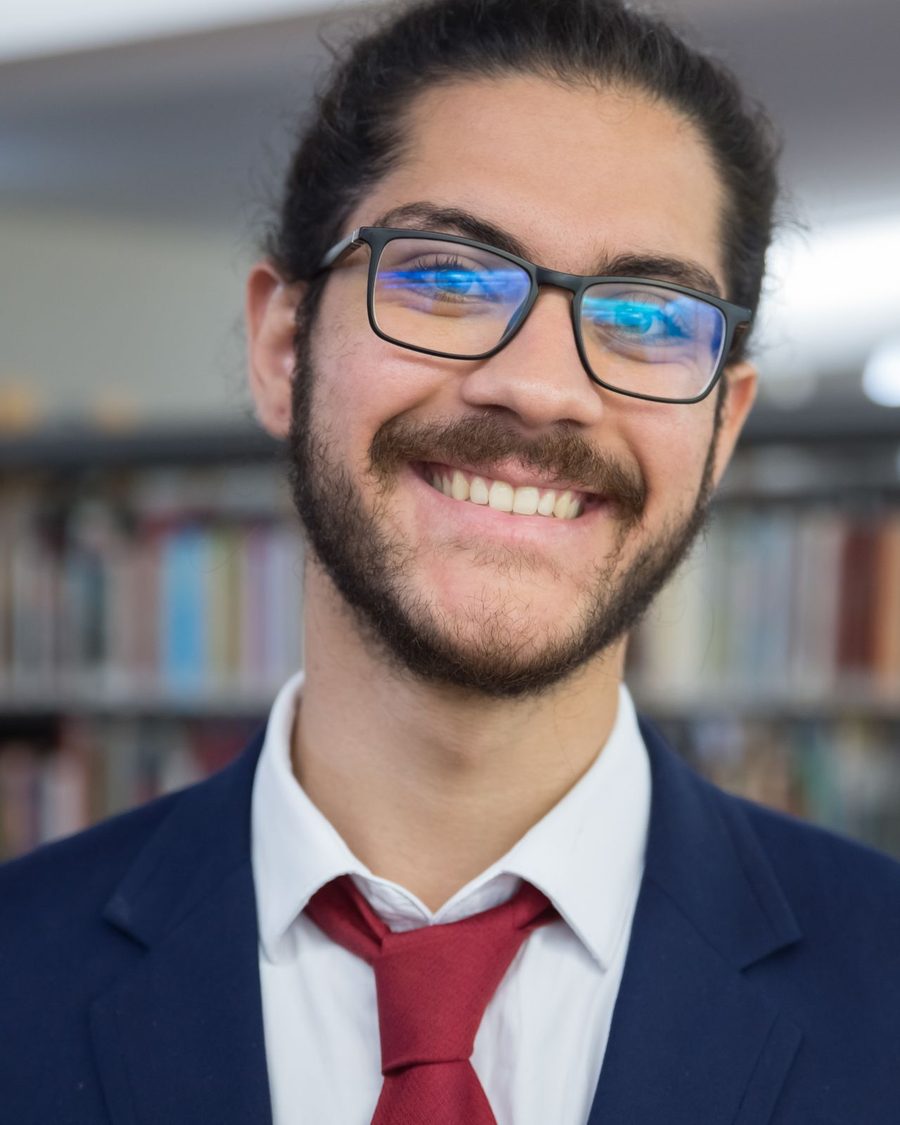 Portrait of a smiling bearded man in glasses and a tie